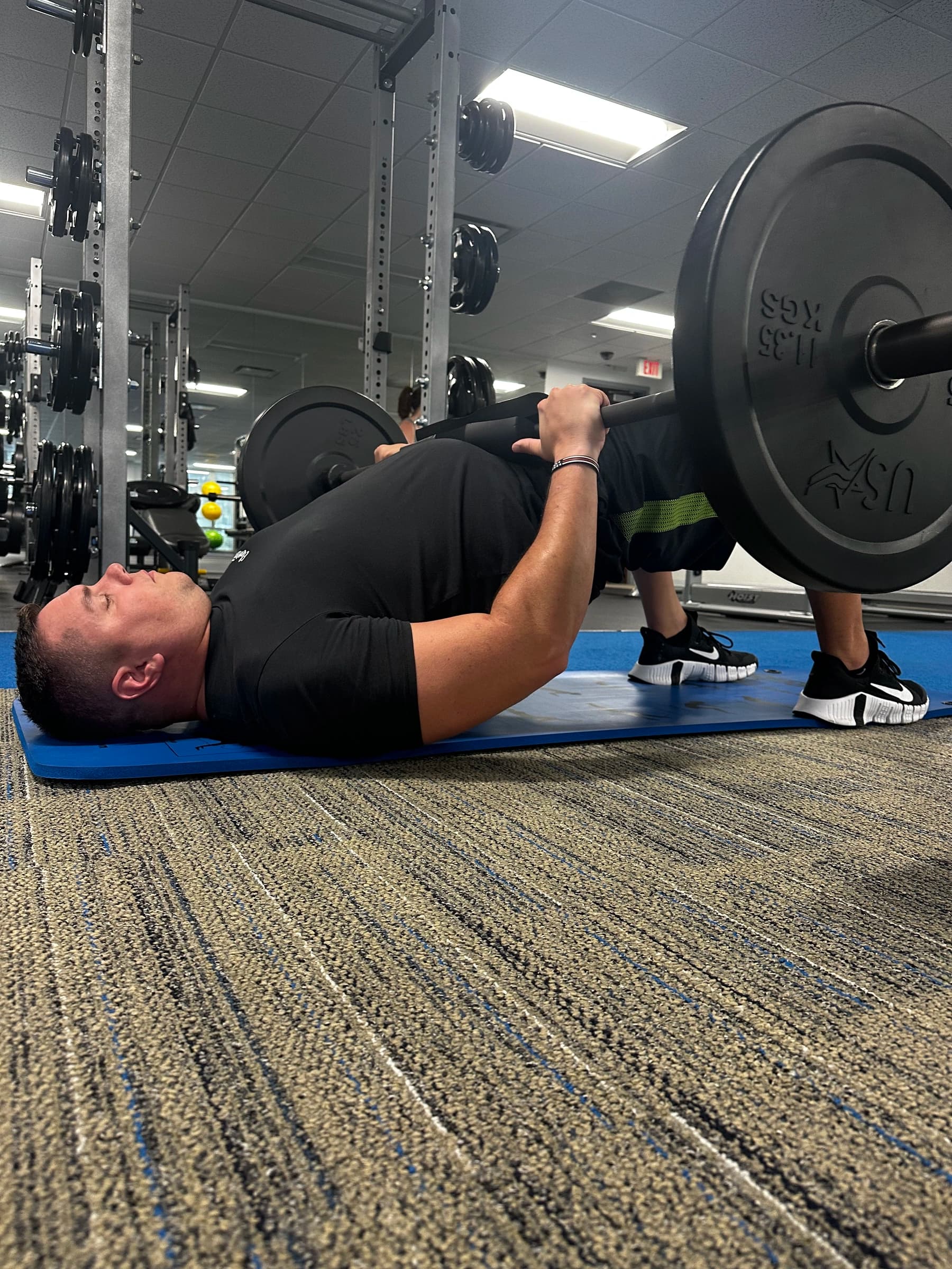Client performing a barbell deadlift during a strength and conditioning session at BodyWRX.