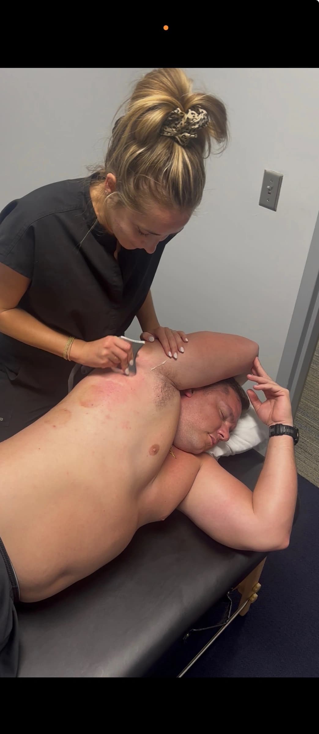 Dr. Mancuso using the Graston Technique on a client's shoulder at BodyWRX.